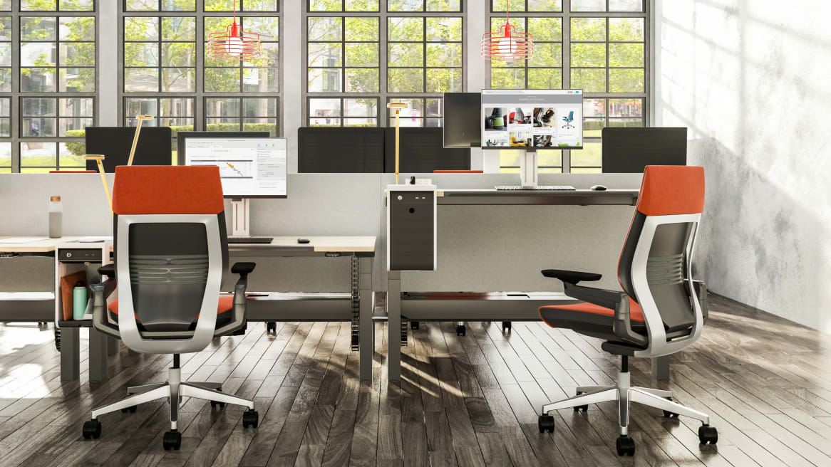 Ology height adjustable benching shown in seated and standing heights with Gesture task chairs at each desk