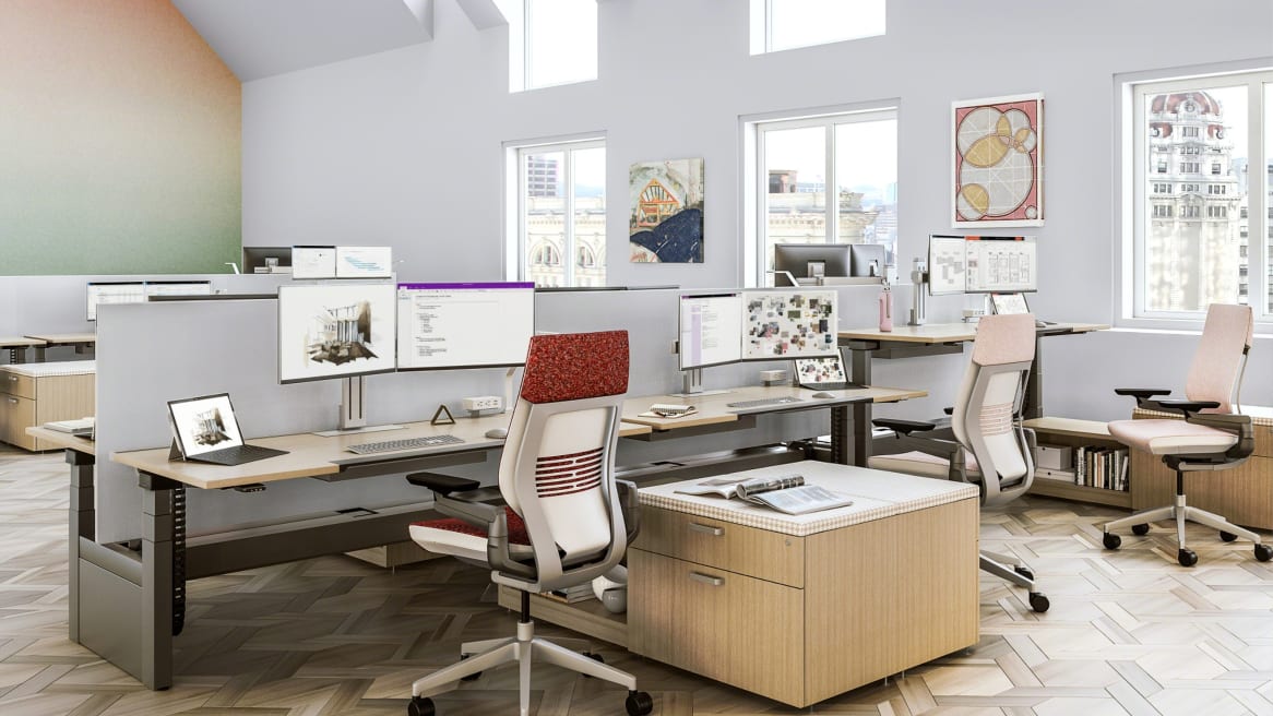Three Ology height adjustable benches in a row with Gesture desk chairs and Universal storage
