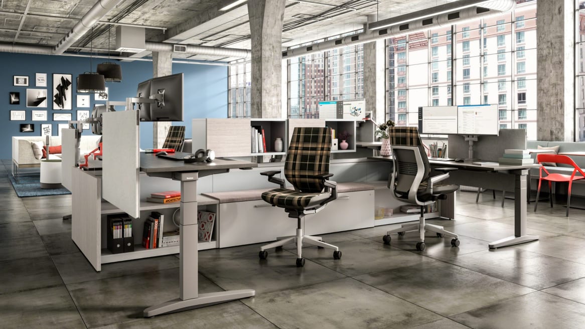 Office setting featuring Answer Beam, Ology height adjustable desks, Universal privacy screens, and Gesture task chairs