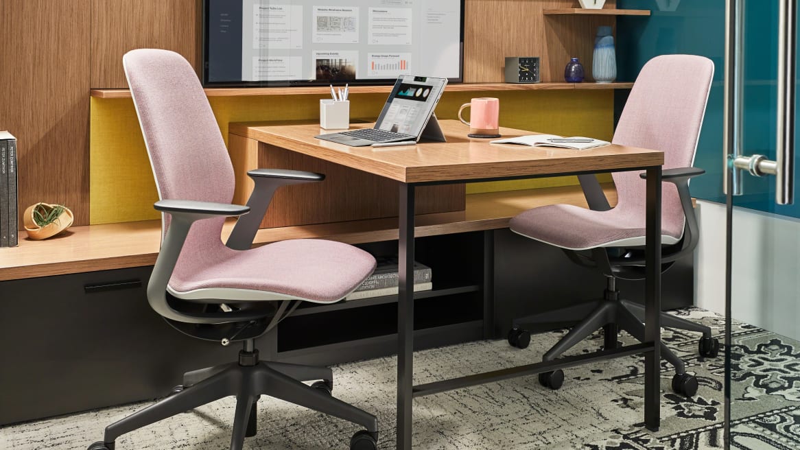SILQ chairs with pink upholstery next to a desk in a private enclave