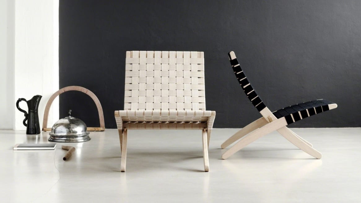 A Cuba chair with a white seat and a Cuba chair with a black seat are seen next to each other
