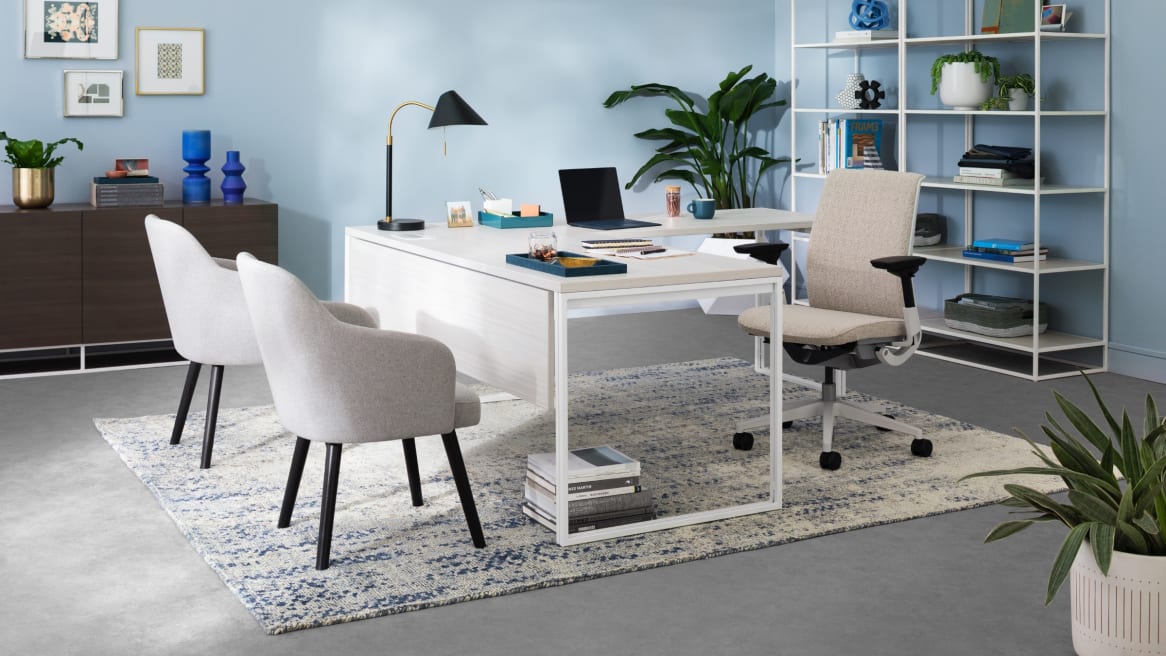 A private office with a West Elm Work Greenpoint desk, storage, West Elm Work Sterling chairs, and a Steelcase Think desk chair