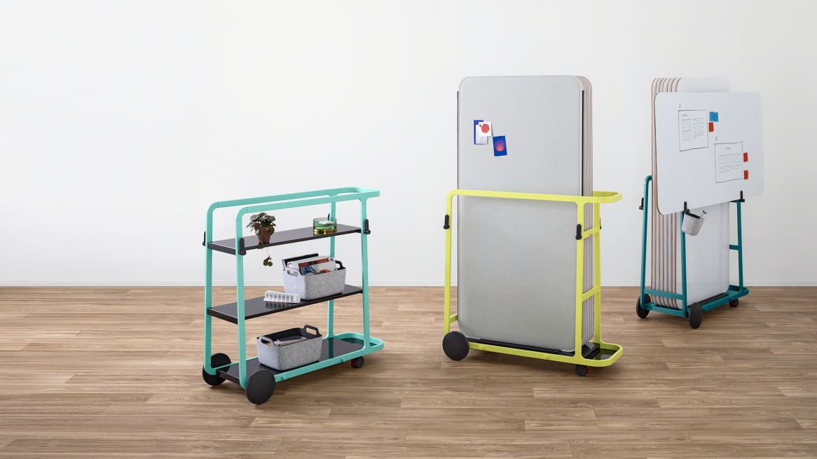 Yellow and teal Steelcase Flex board carts are shown carrying boards while a mint green Steelcase Flex team cart is shown nearby