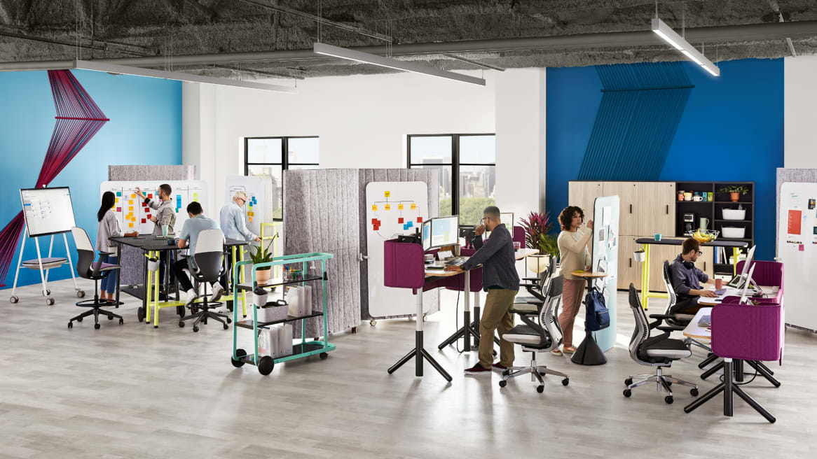 A group of people works in an office environment created with Steelcase Flex Collection products