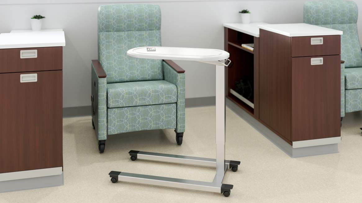 Image of Mobile Overbed Table with Oval top and C Base, Arctic White, MIneral Recliner with wood arm caps, Designtex Crosswind Wave, Sonata Double-sided Island with open storage and laminate top and divider, Sonata Nurse Sever with Waste Bin Storage and Laminate top, Arctic white