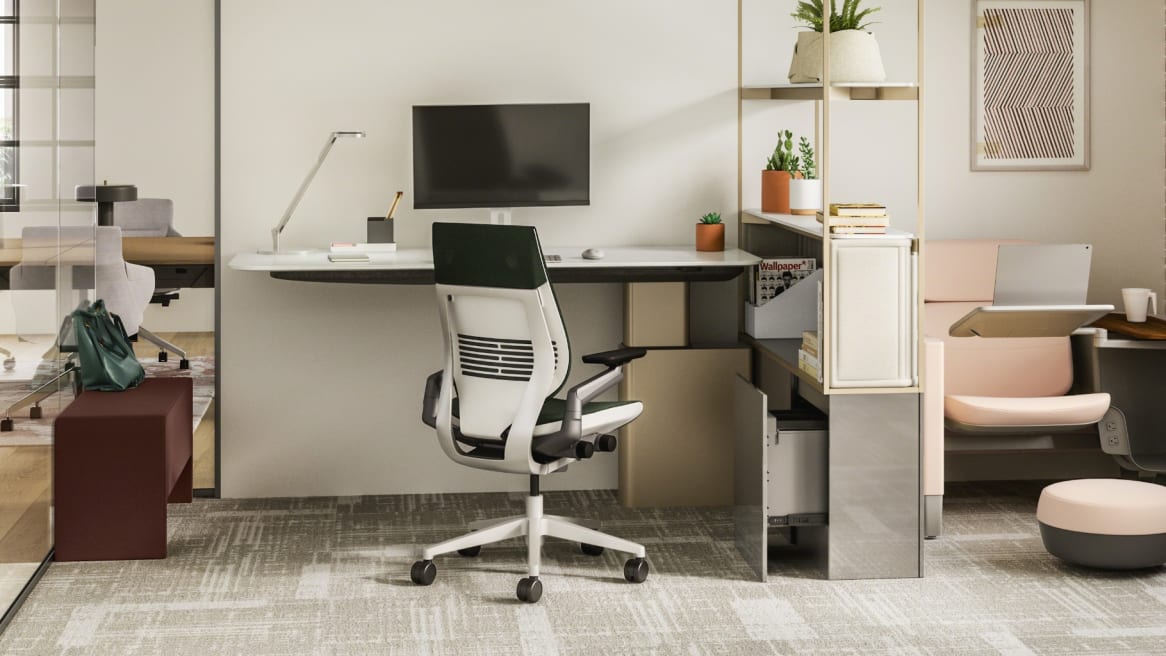 Work space with a desk and monitor, a white and black Gesture chair