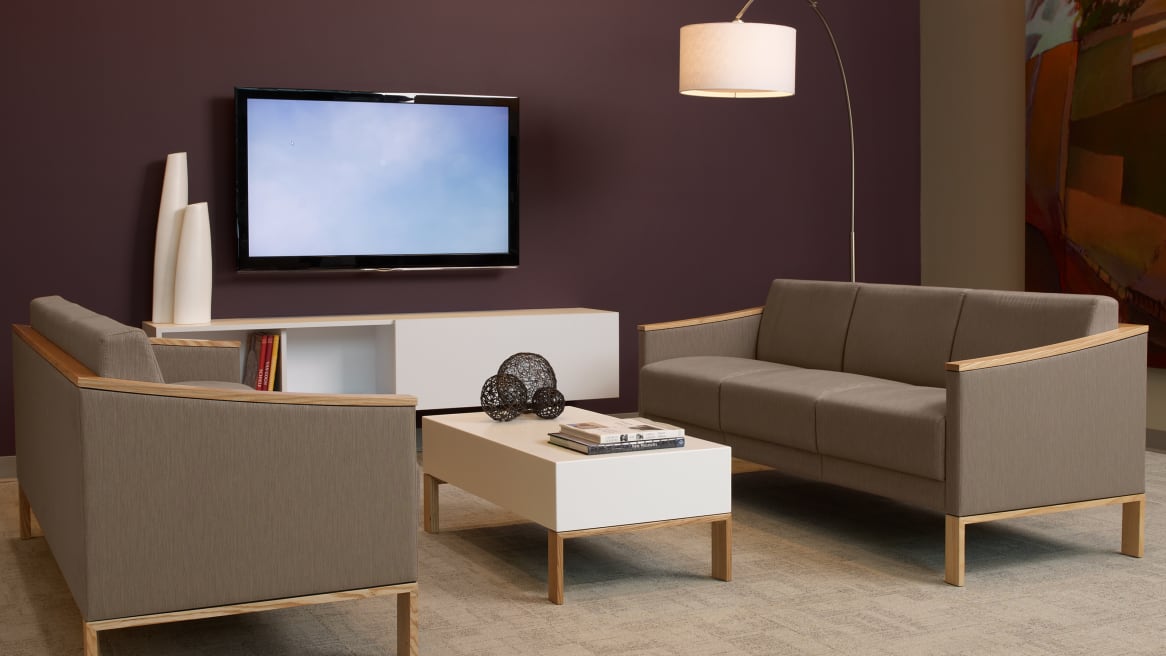 Tan Tava Loveseat, Sofa and Single Chairs around a White Coffee Table in a waiting room