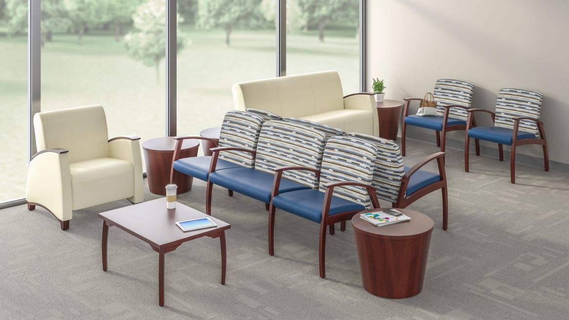 Health waiting space equipped with beige Mitra Guest Single-Seat, Lounge, Sofa, a Bariatric Combination Unit and wooden Tables