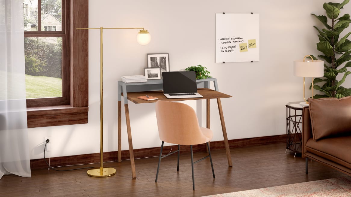 Home office space equipped with PolyVision Nota, a wooden desk and a light brown chair.