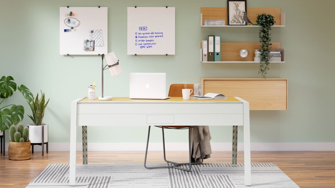 Home office space equipped with PolyVision Nota whiteboards, a large light-gray desk and brown chair.