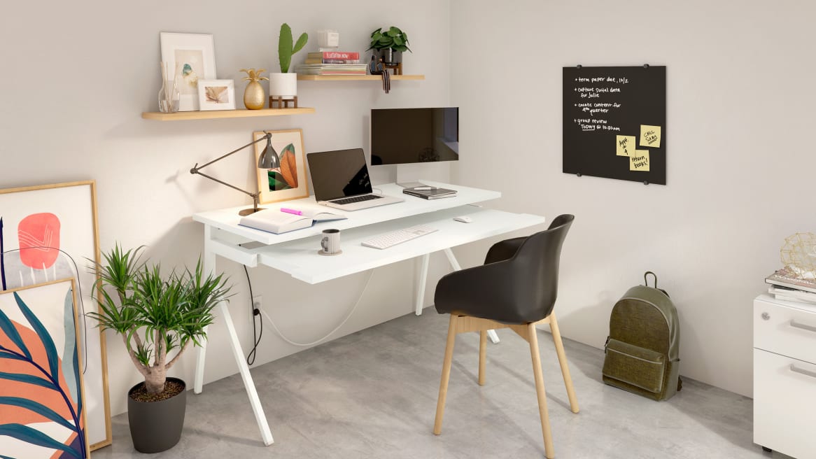 Home office space equipped with PolyVision Nota chalkboard, a white desk and a black chair.