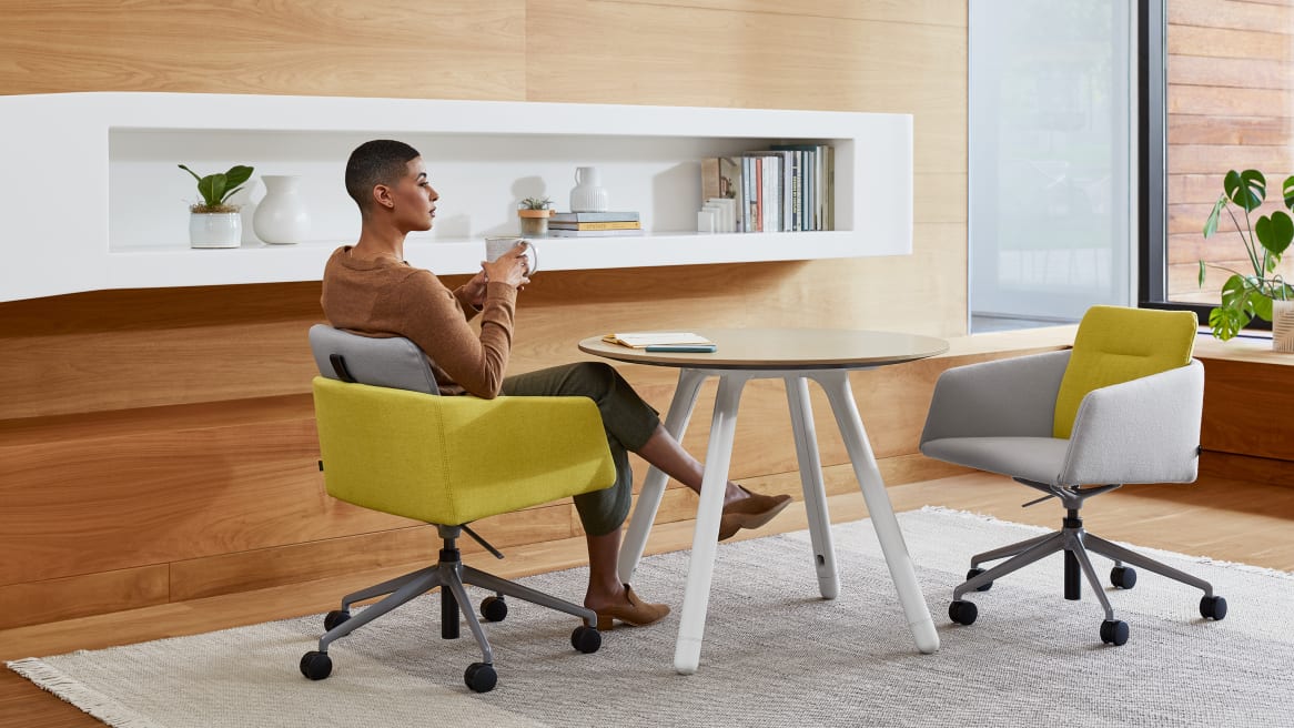 woman seated on a Marien152 Seating Collection and Potrero415 Light Table Cafe