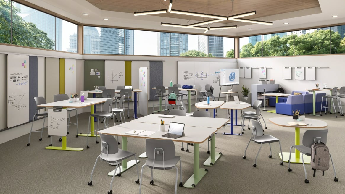 Classroom setting featuring gray Shortcut tripod-base chairs, white Shortcut 5-star base stool-height chairs, and Verb tables