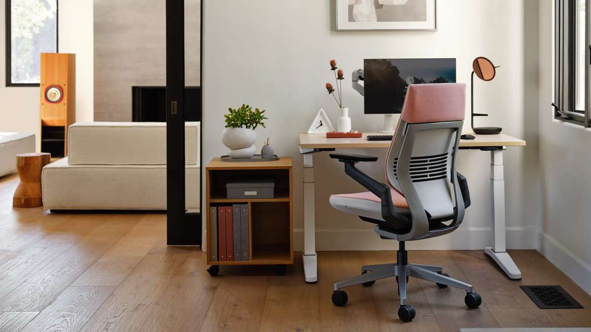 Office at home, with a chair in front of a computer.
