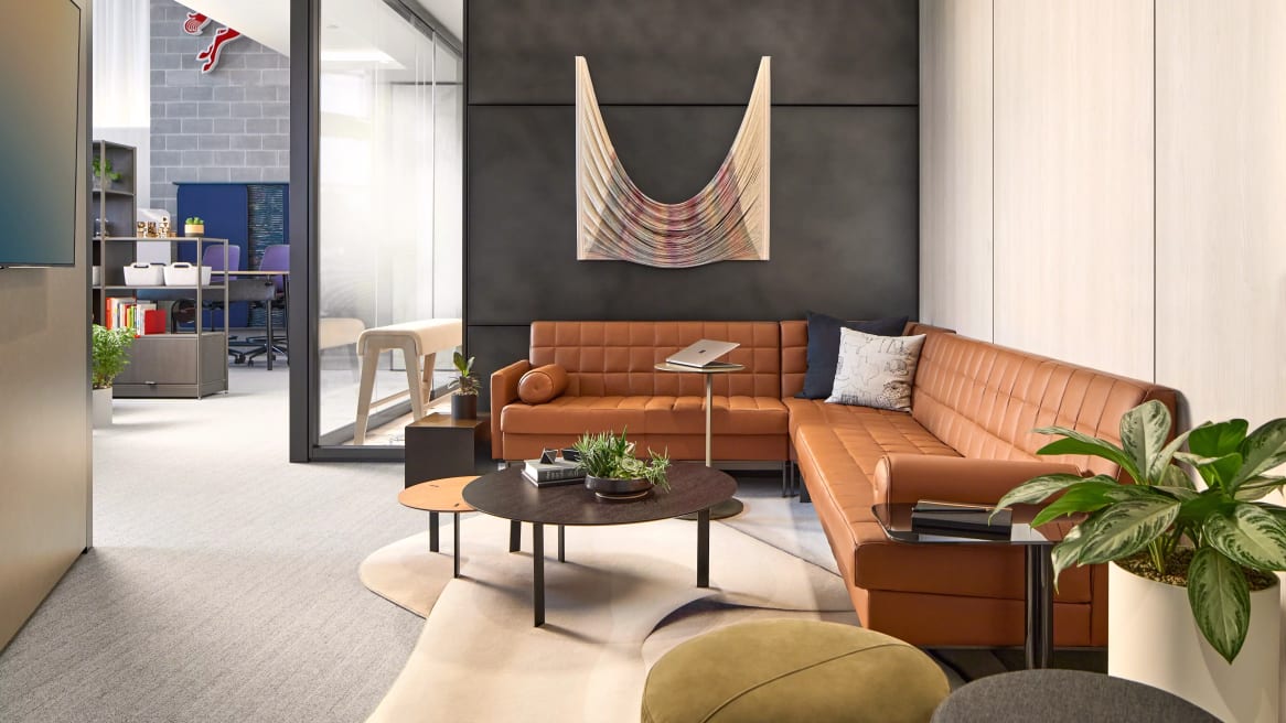 Living room in office with orange sofas