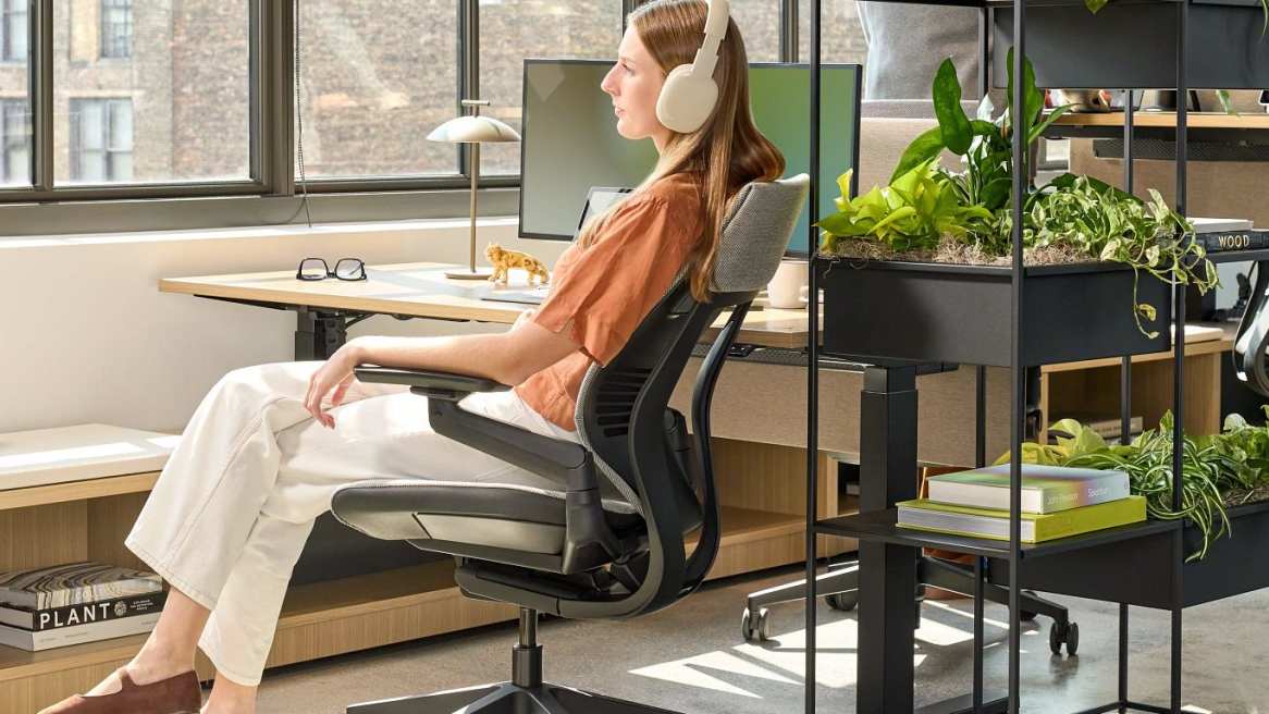 Woman sitting on Gesture Chair in an office environment