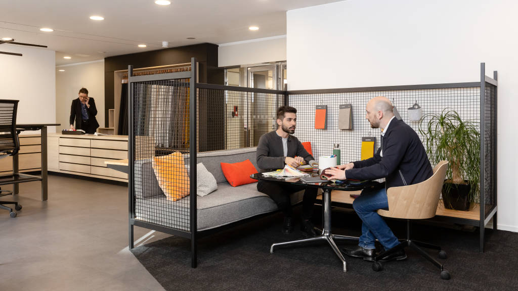 two men collaborating in a Established and Sons sofa