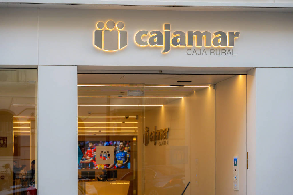 Entrance of a Cajamar Caja Rural office with illuminated logo signage