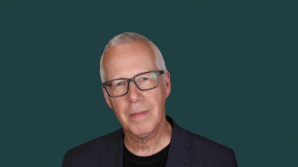 Image showing a headshot of Jeremy Myerson, international research leader specialising in the intersection of inclusive design, healthy cities and the future of work, on a green background