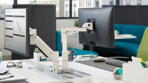 Two White CF Series Monitor Supports back-to-back on workstations