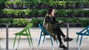 Lakeland Community College Case Study woman seating at a table, LessThanFive chair