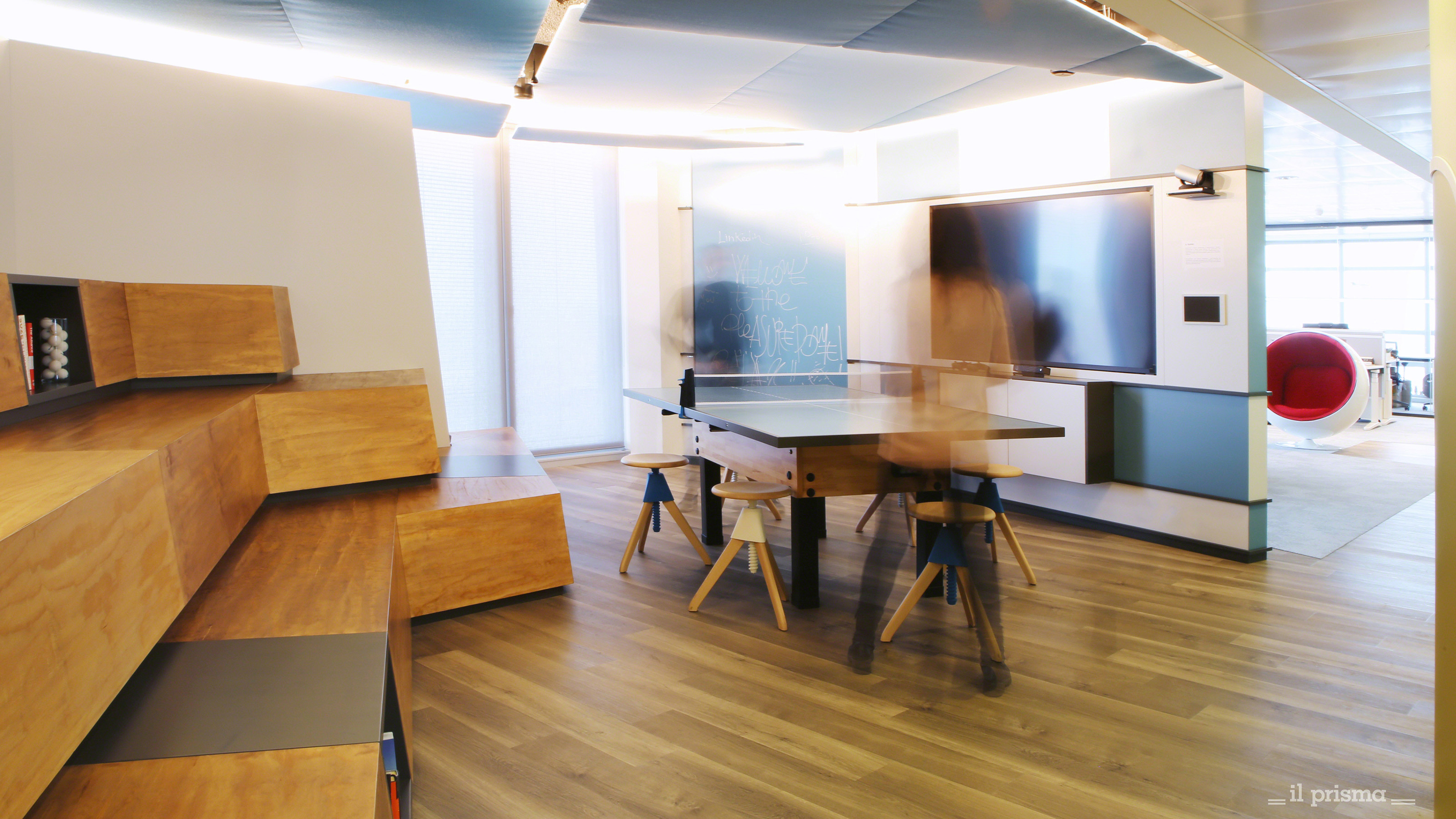 Gathering space at LinkedIn office in Milan, ping pong table and a big TV screen