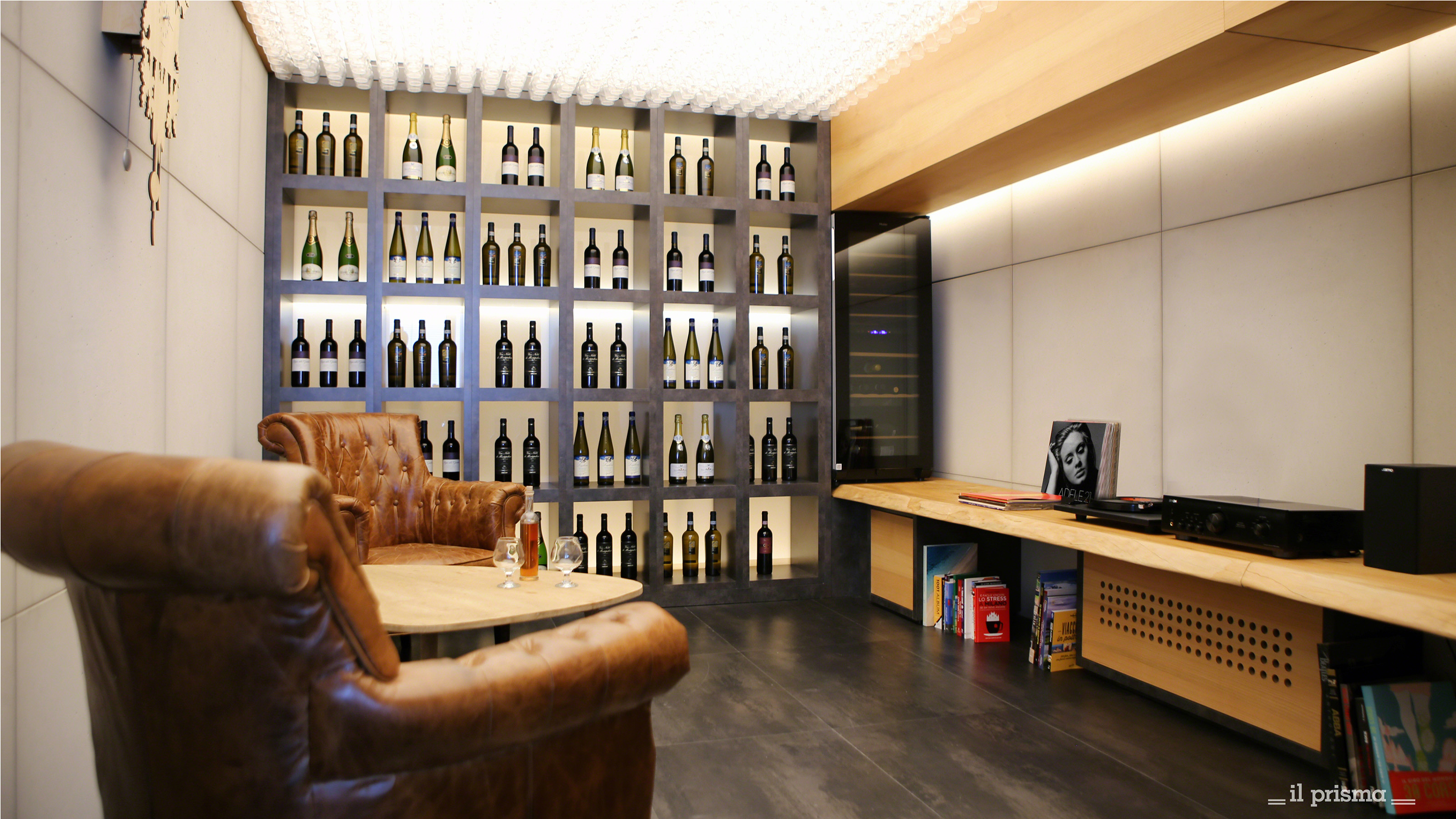 LinkedIn gathering area with a wine wall, two lounge chairs and wooden table