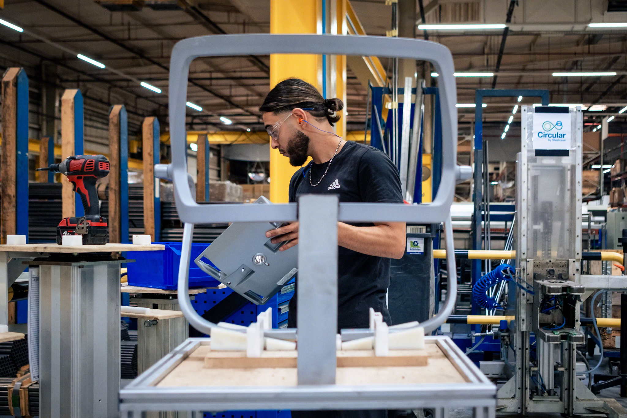 Factory worker in the assembly area of an industrial setting